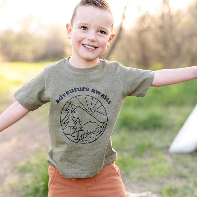 Adventure Awaits|2T|3T|4T|5T|Youth Small|Youth Med|Youth Large|Heather Yellow Gold|Natural|Peach|Ice Blue|White|Military Green